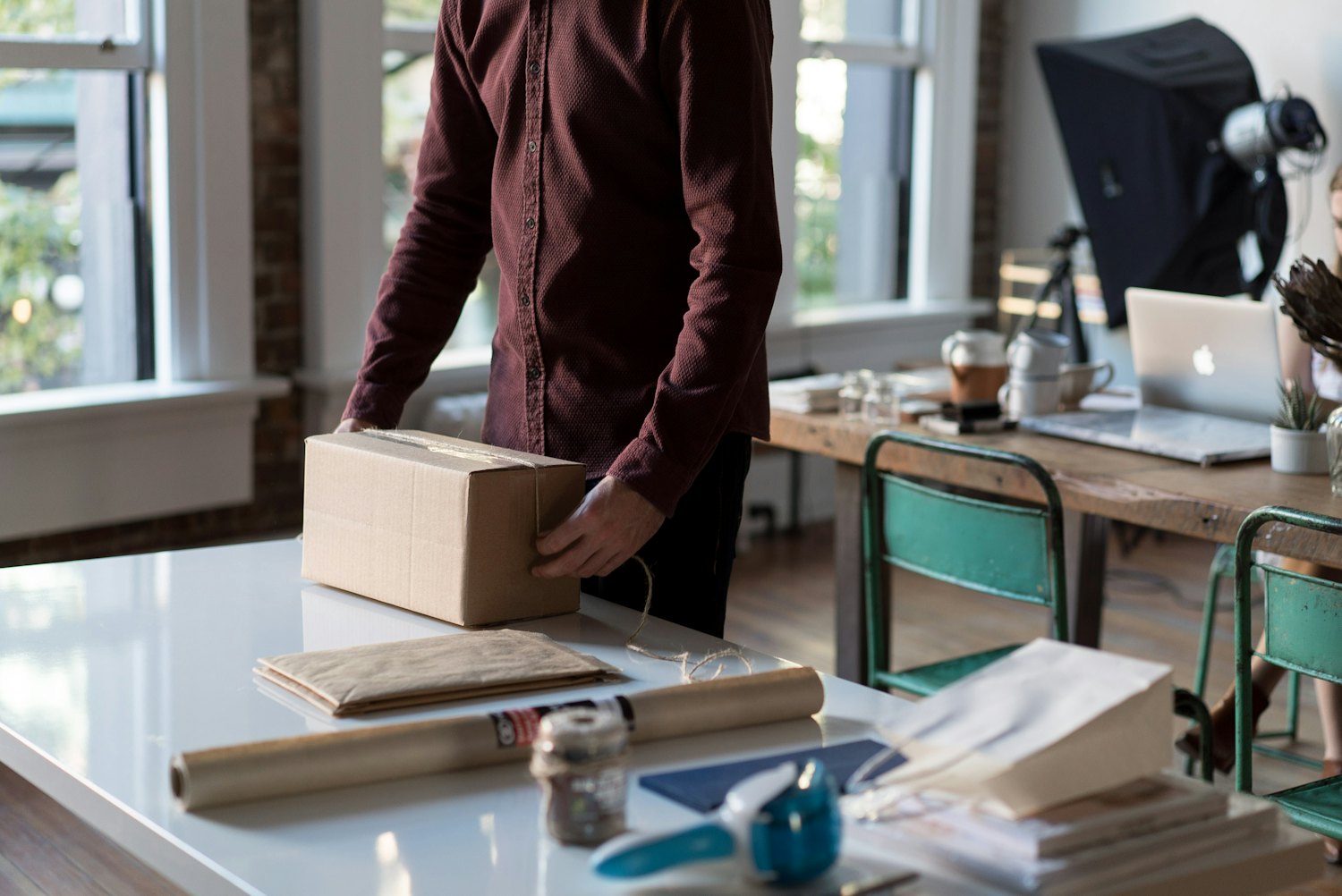 A small-business owner packing an order at a table